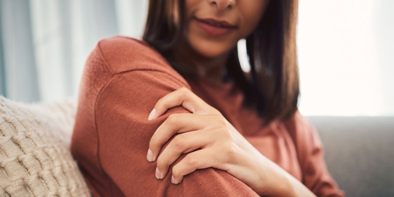 Woman grasping her arm